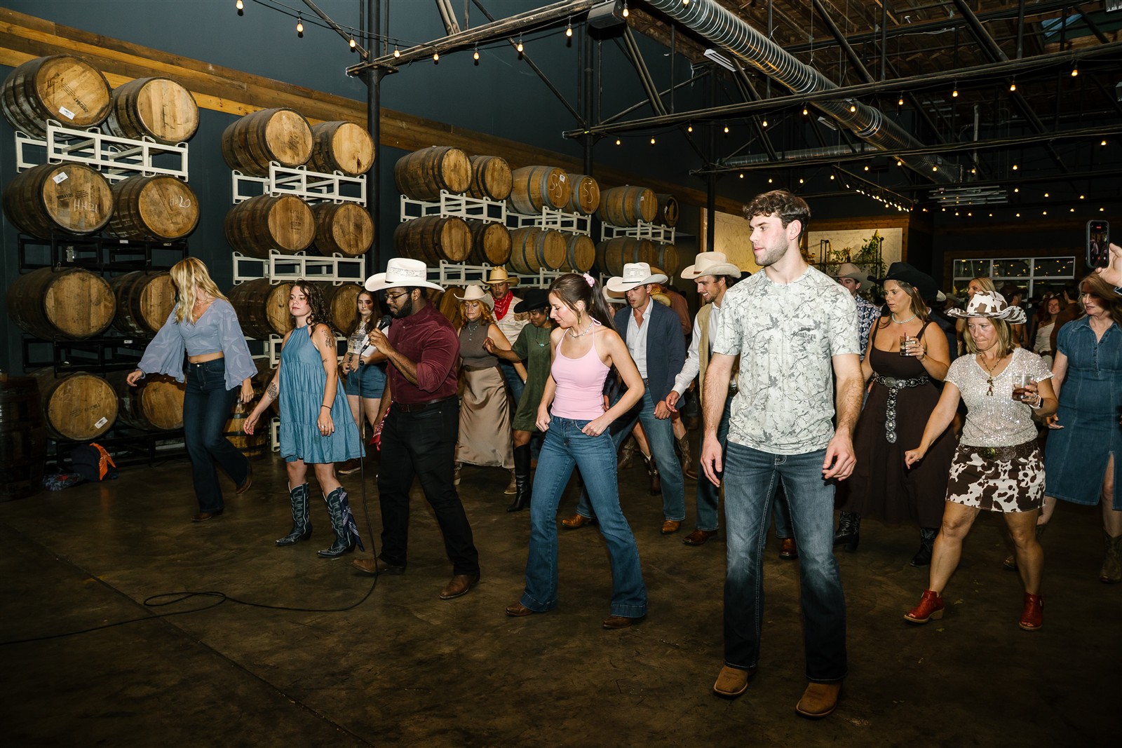 Guests line dancing together at a private event